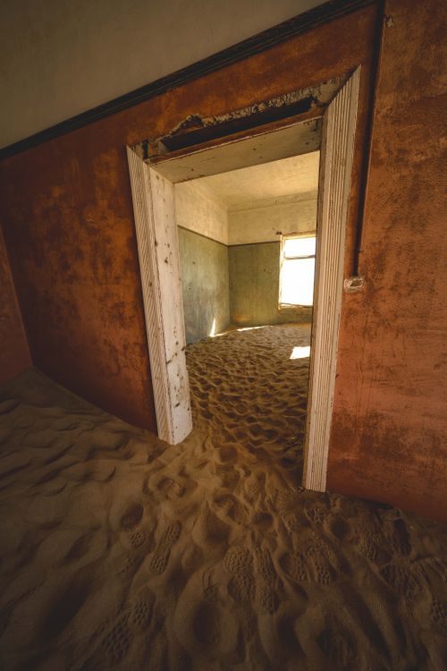 Free Explore the haunting beauty of a sand-filled room in the ghost town of Kolmanskop, Namibia. Stock Photo