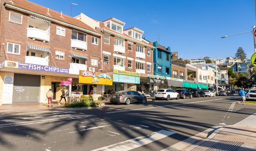 Free Colorful street view of Bondi Beach, Sydney with shops and pedestrians on a sunny day. Stock Photo