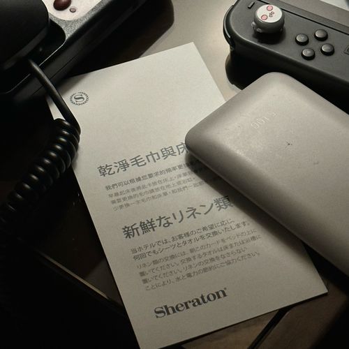 Handheld console and charging accessories arranged for travel, a portable setup common among gaming daters