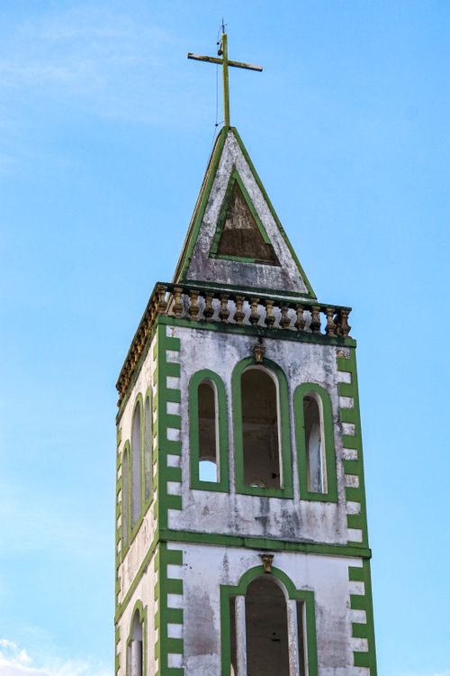 Free A striking bell tower featuring green and white architecture under a clear blue sky in Belém, Brazil. Stock Photo