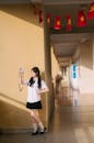 Schoolgirl Taking Selfie in Sunny Hallway