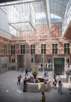 Captivating interior of the Rijksmuseum in Amsterdam showcasing modern architecture and vibrant activity.