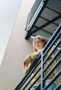 Woman Wearing Yellow Sweater Leaning on Railing