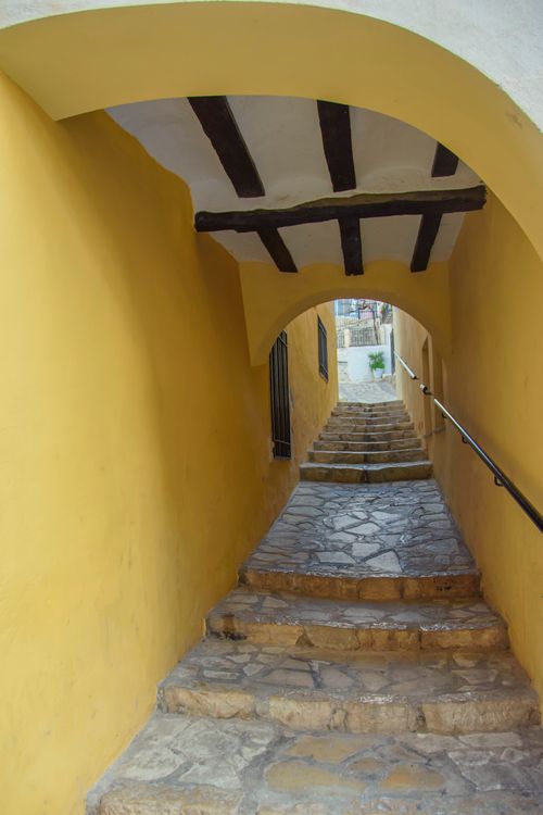 Free A picturesque stone stairway with yellow walls in Finestrat, showcasing traditional Spanish architecture. Stock Photo