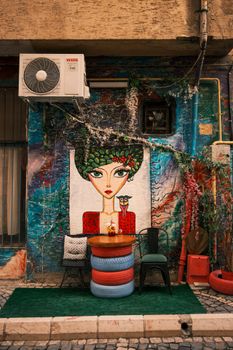 Vibrant street art with café seating creates an artistic urban vibe.