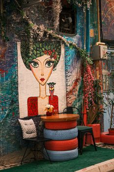 Vibrant street art mural with seating, showcasing urban creativity.