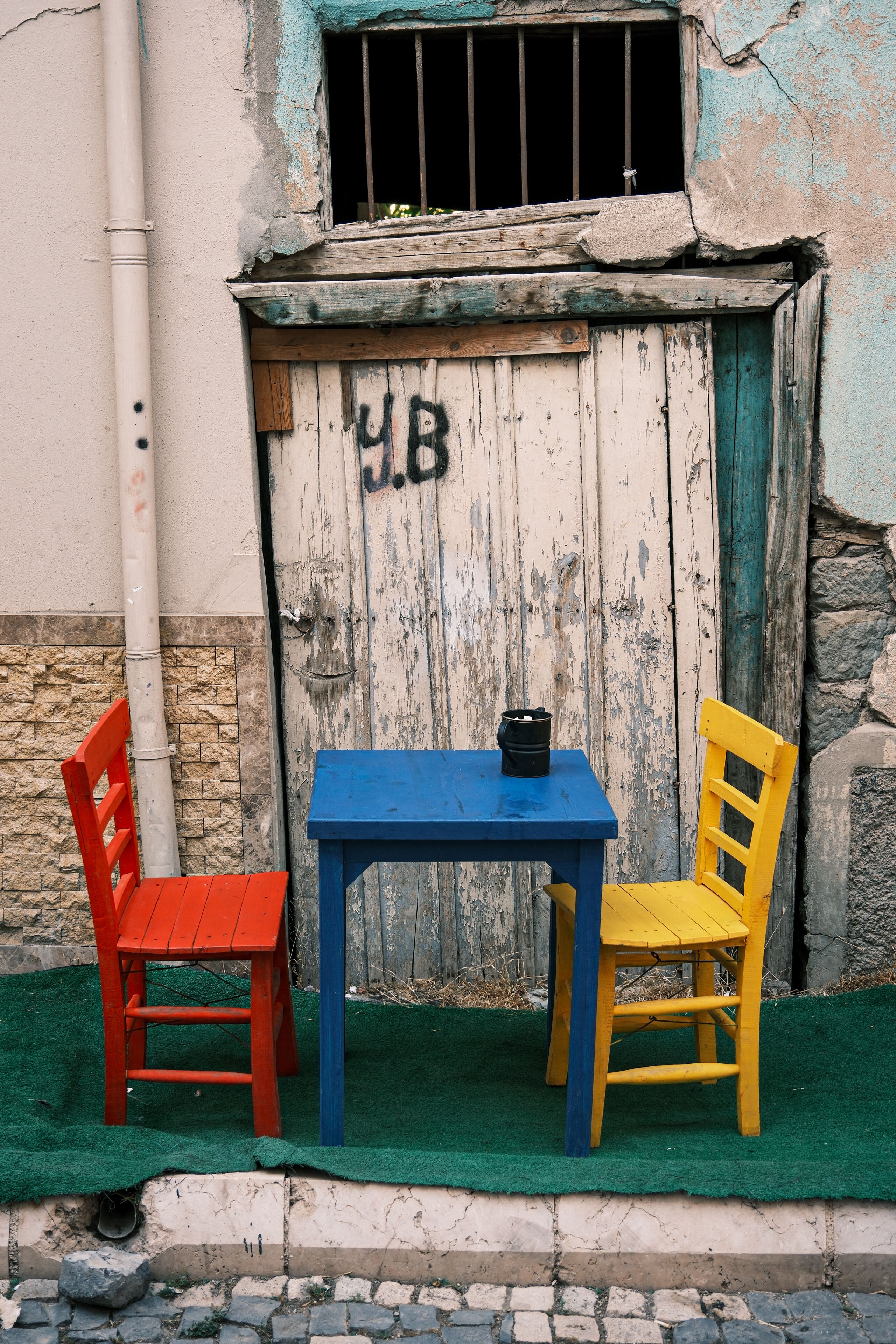 Colorful Chairs and Table Outside Rustic Doorway · Free Stock Photo