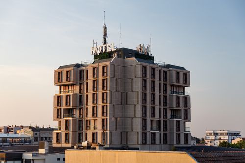 Free A modern hotel building in Pančevo, Serbia, captured during sunset with clear skies. Stock Photo