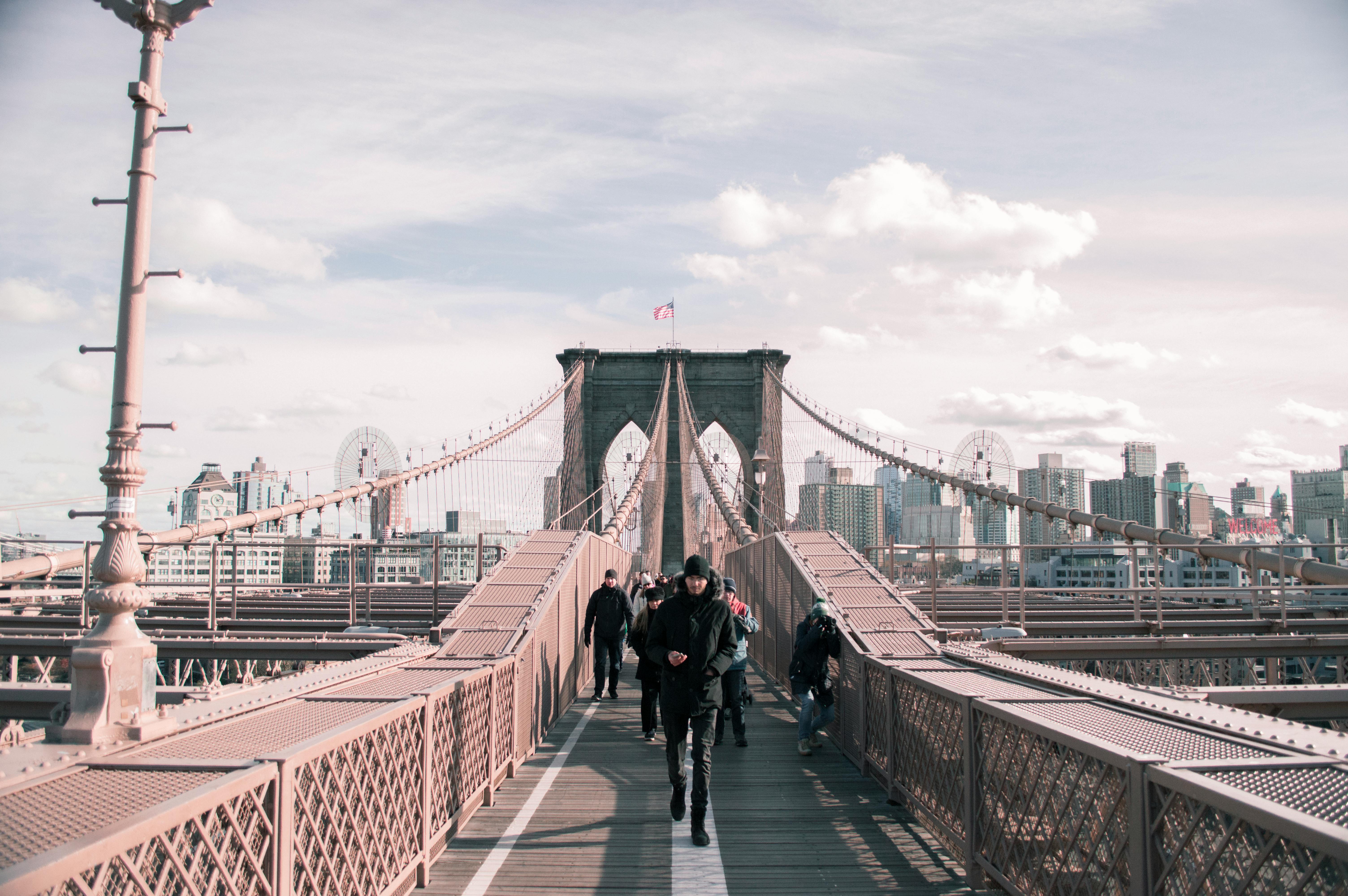 People Walking On A Wooden Footbridge
