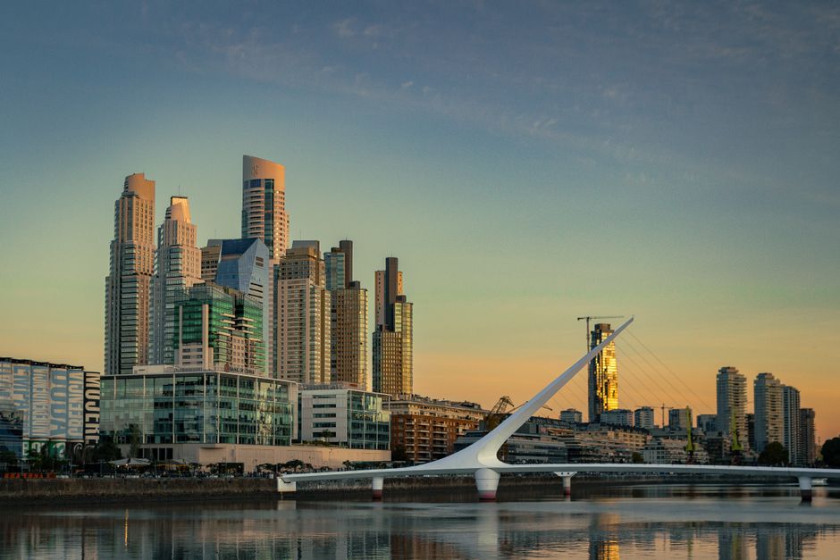 Stunning view of Puerto Madero's skyline during sunset with the iconic Puente de la Mujer bridge.