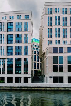 Stylish modern architecture with glass facades by a river in Minsk, Belarus.