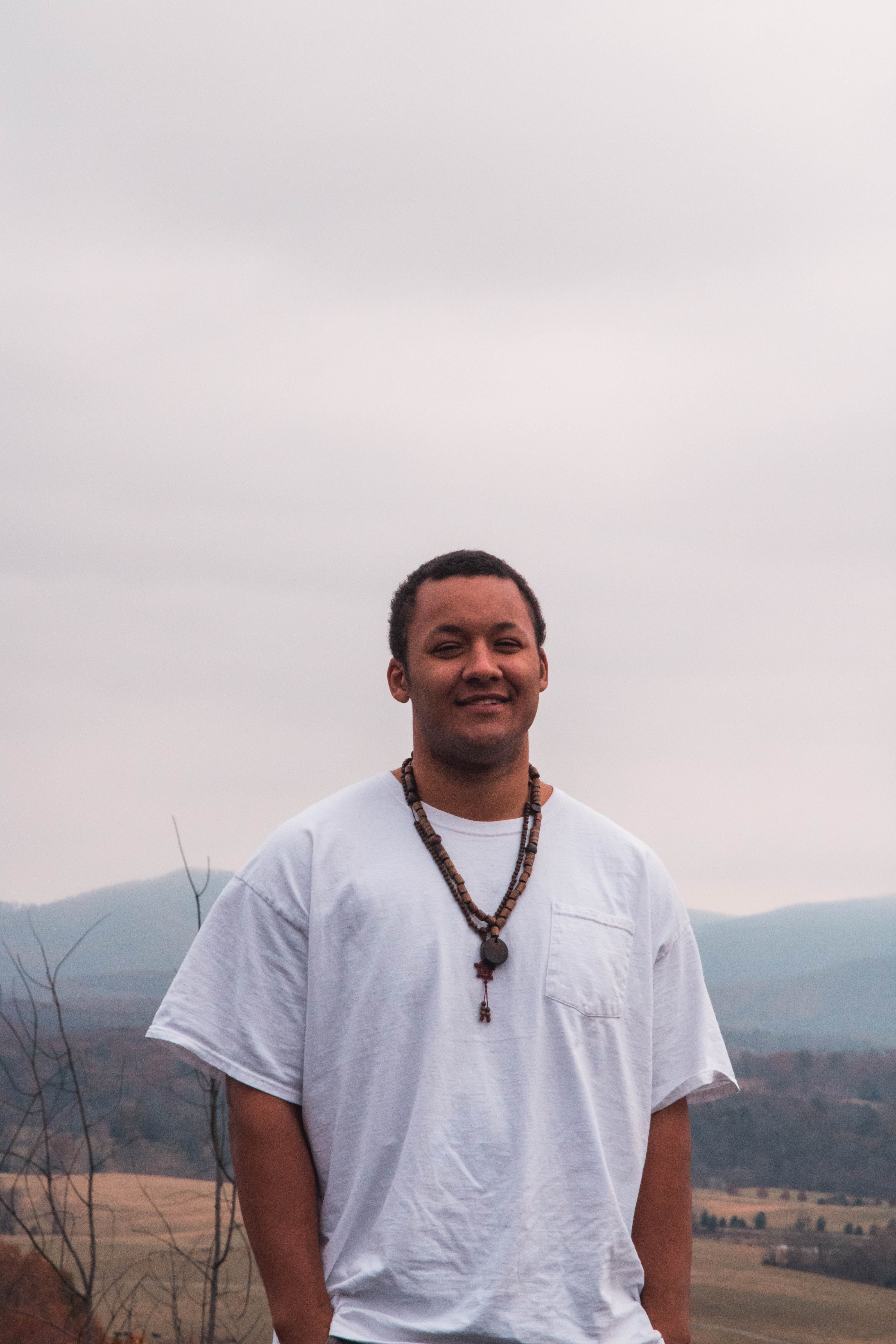 Casual portrait of a smiling man in a white shirt amidst Virginia landscape.