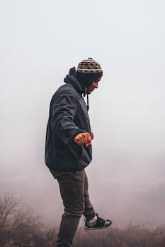 在弗吉尼亚州斯汤顿，一个穿着休闲装的家伙在雾蒙蒙的悬崖上展示冬季时尚