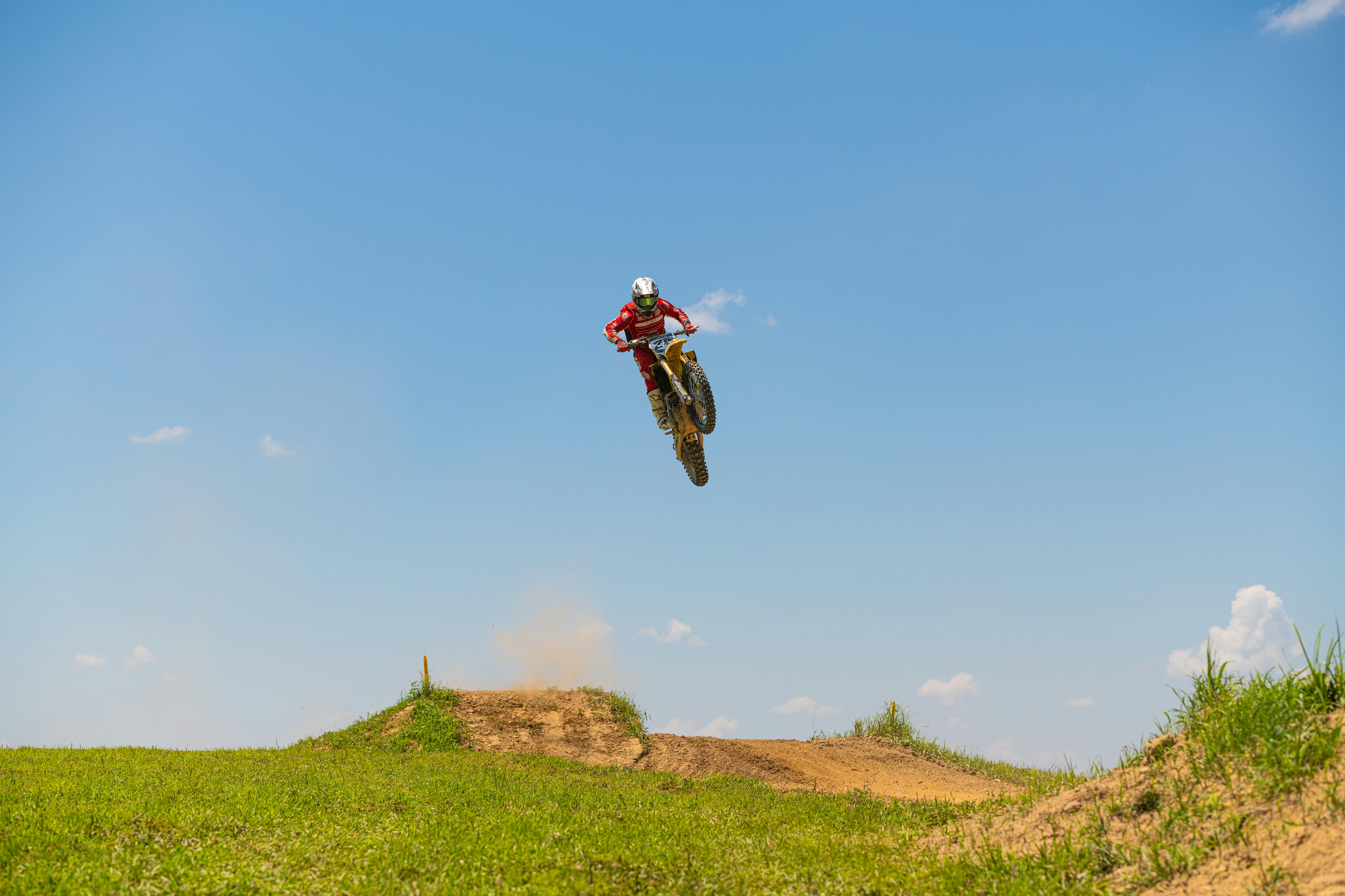 High-Flying Motocross Jump in Sunny Terrain · Free Stock Photo, image size:1125x750
