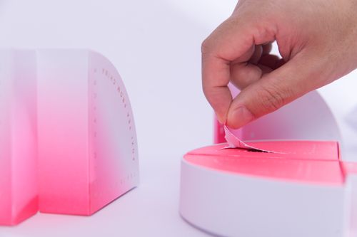Free A hand touching a gradient pink and white abstract sculpture in a close-up shot. Stock Photo