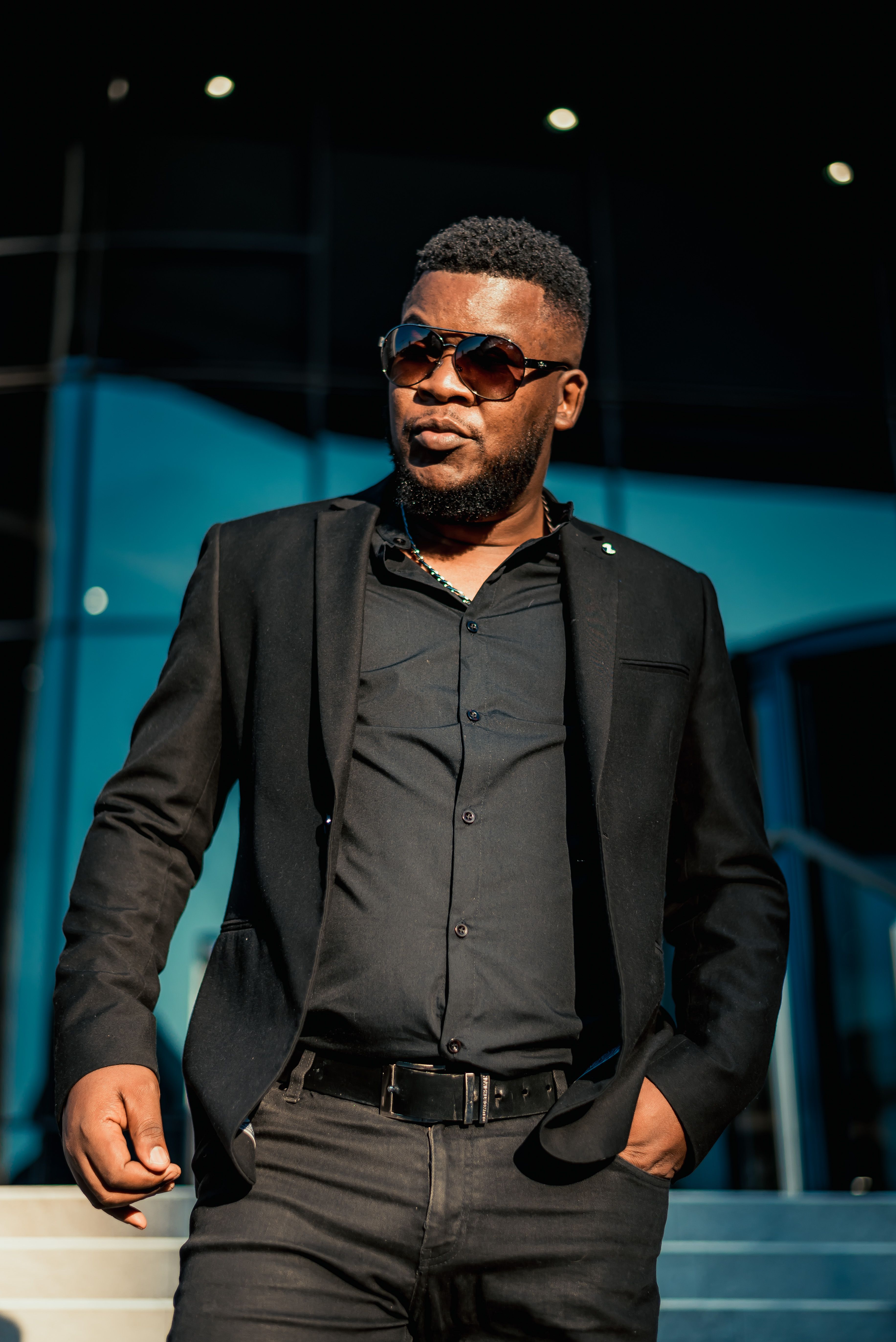 Confident Man in Black Suit with Sunglasses Outdoors · Free Stock Photo