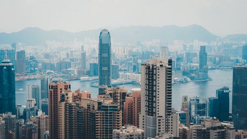 Free A cityscape of Hong Kong featuring skyscrapers and Victoria Harbor. Stock Photo