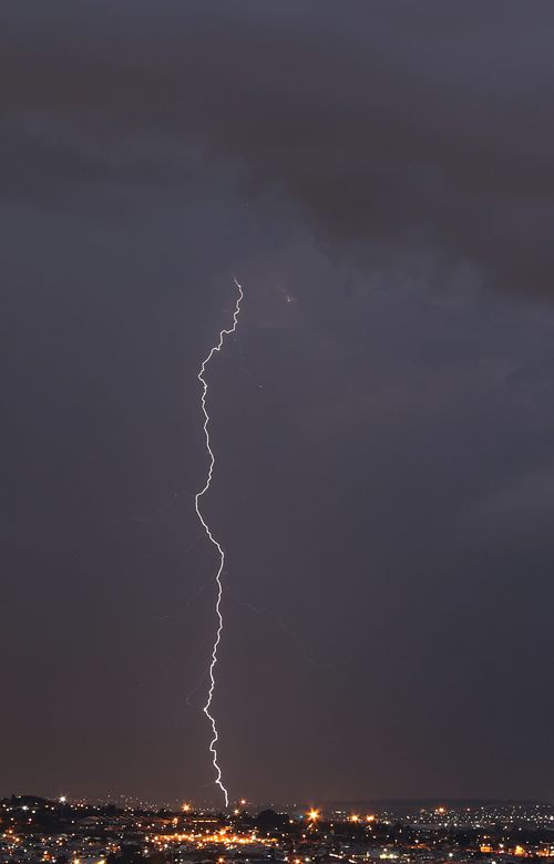 Free Stunning capture of a lightning bolt illuminating the night sky over Johannesburg cityscape. Stock Photo