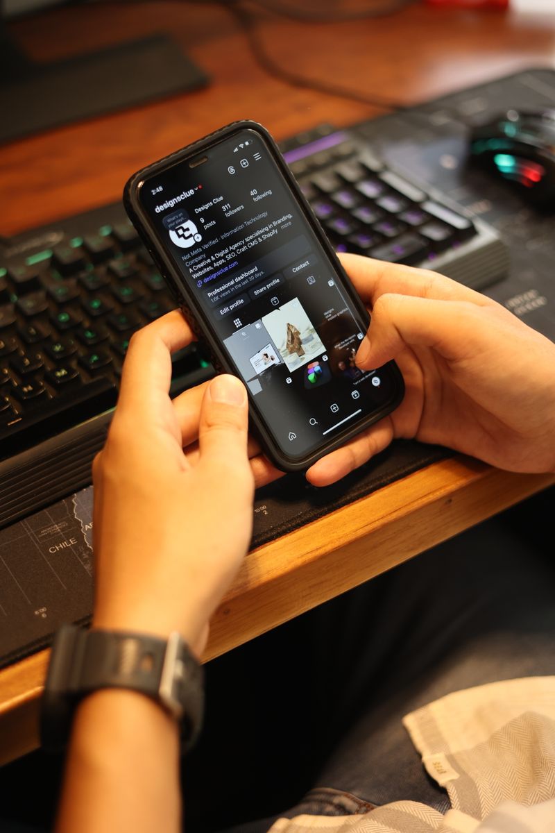 A person browsing social media application interfaces on a smartphone