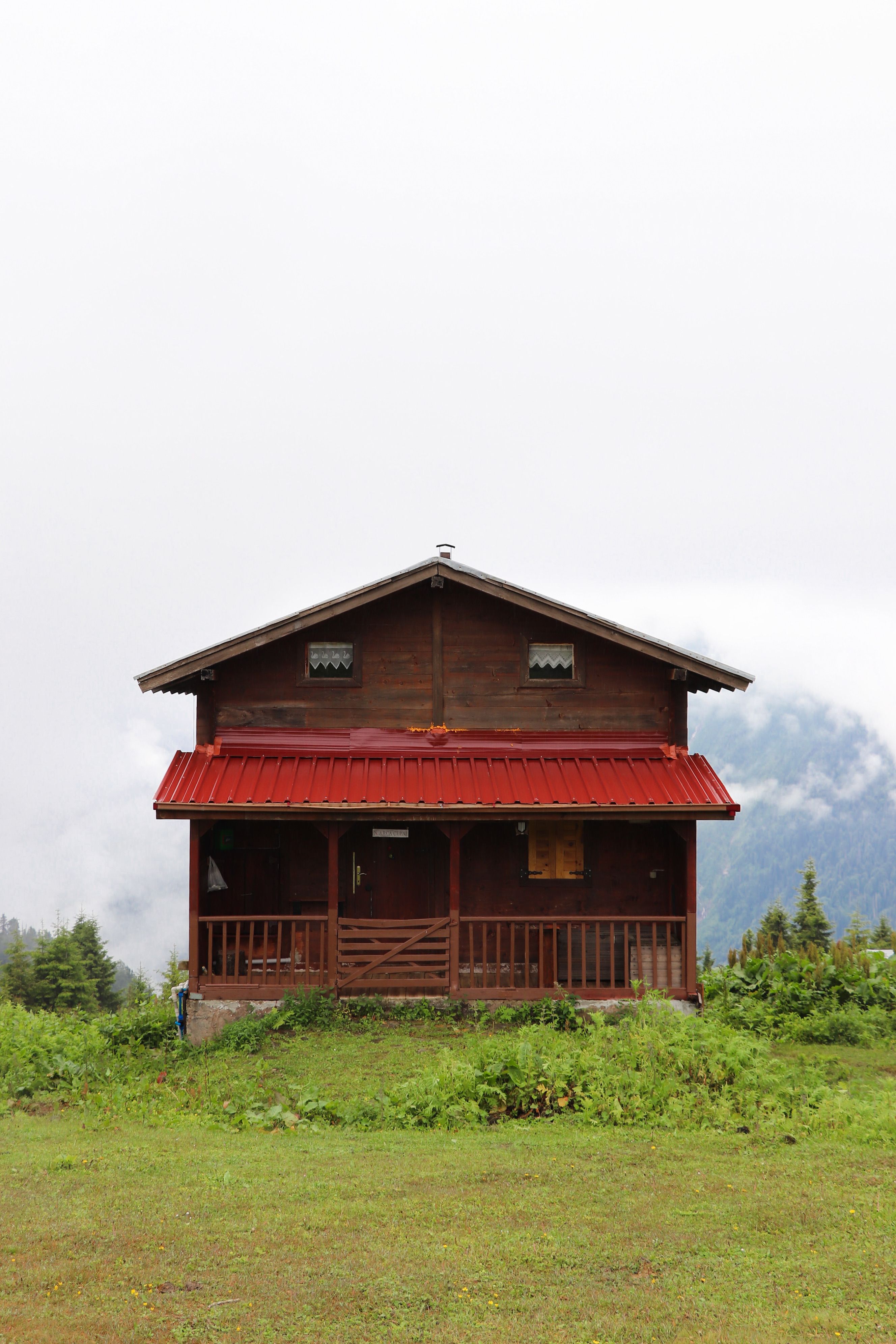 Rustic Wooden Cabin in Misty Mountain Landscape · Free Stock Photo