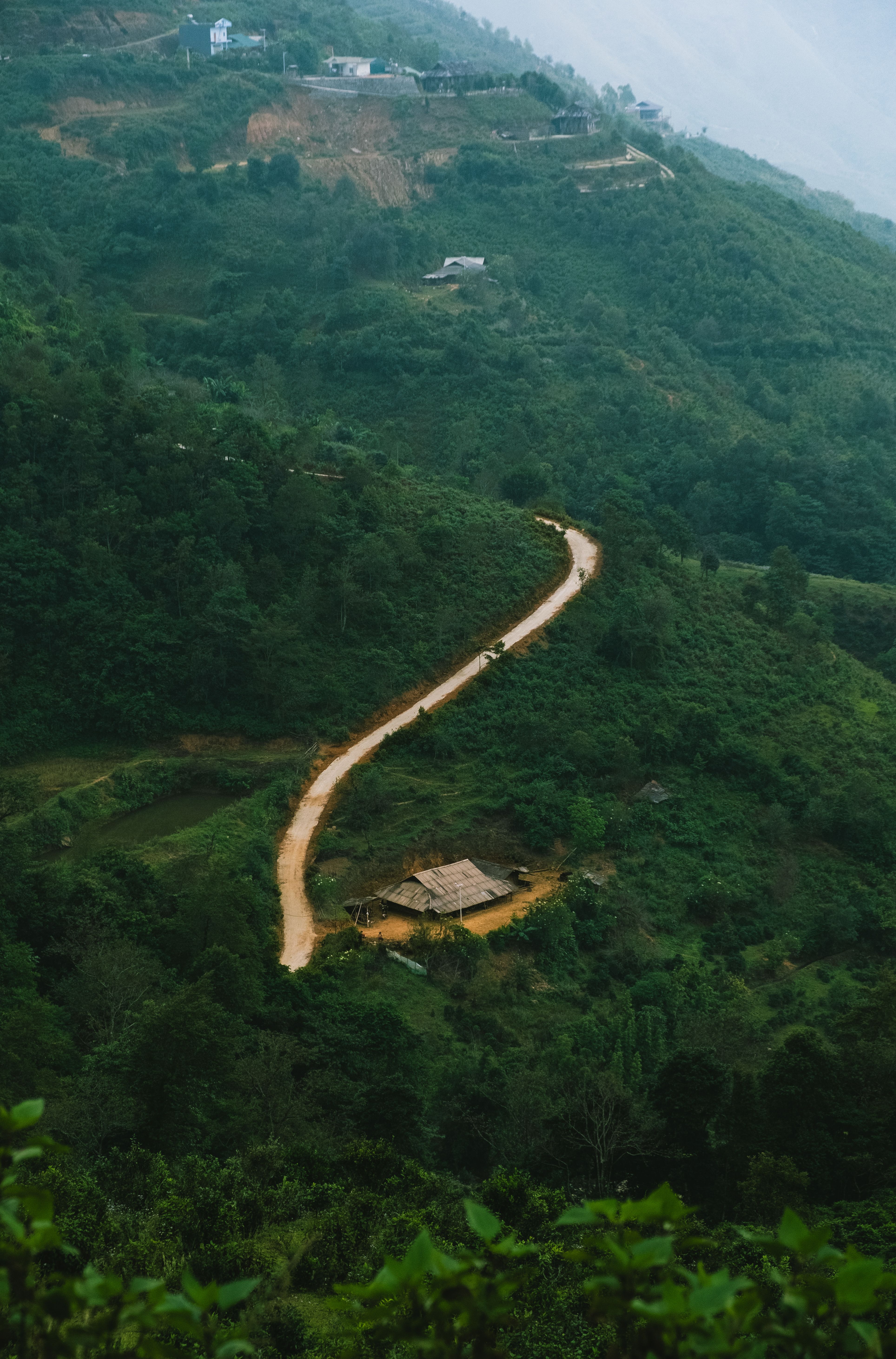 Winding Path Through Lush Green Hillside Landscape · Free Stock Photo
