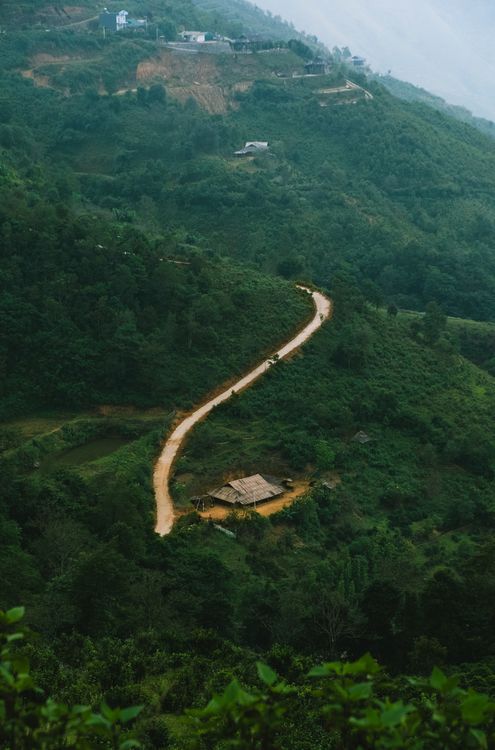 Winding Path Through Lush Green Hillside Landscape · Free Stock Photo