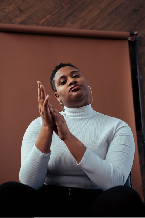 Woman Wearing White Turtleneck Sweater and Black Pants