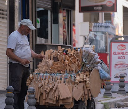A street vendor offers handcrafted wooden kitchenware in İzmir, Türkiye.