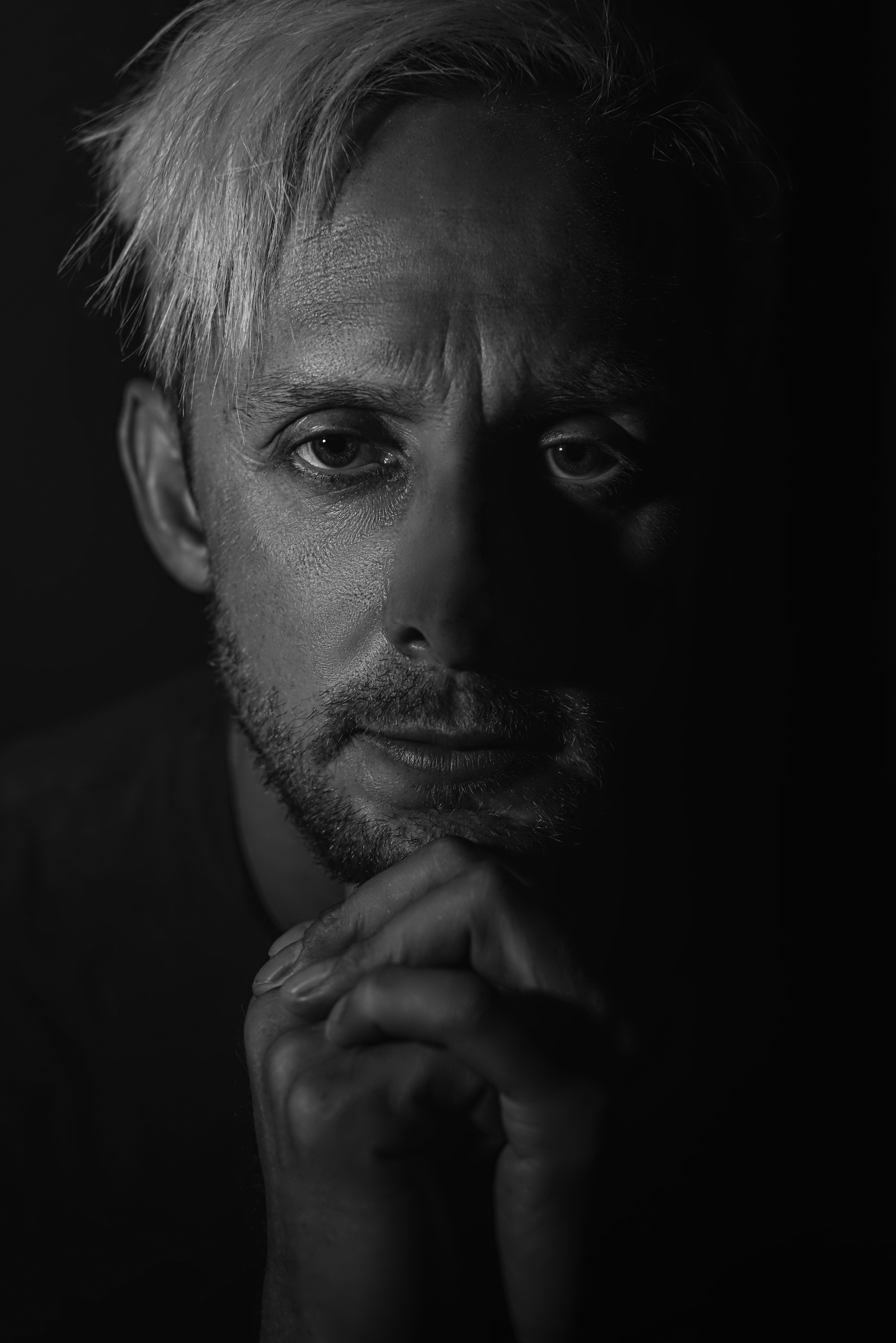 Dramatic Black and White Portrait of a Contemplative Man · Free Stock Photo