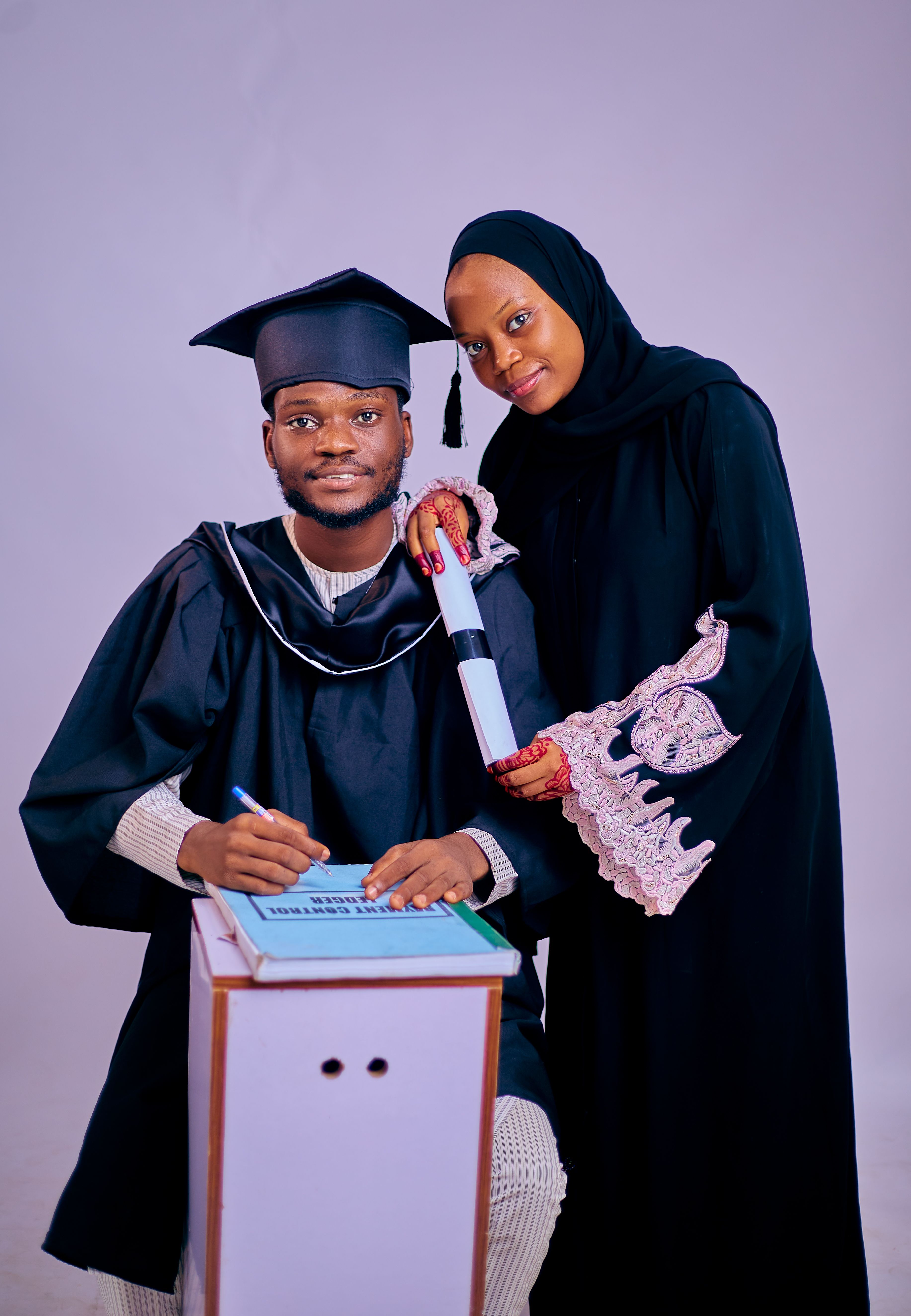 Graduation Portrait of Two Adults in Traditional Attire · Free Stock Photo