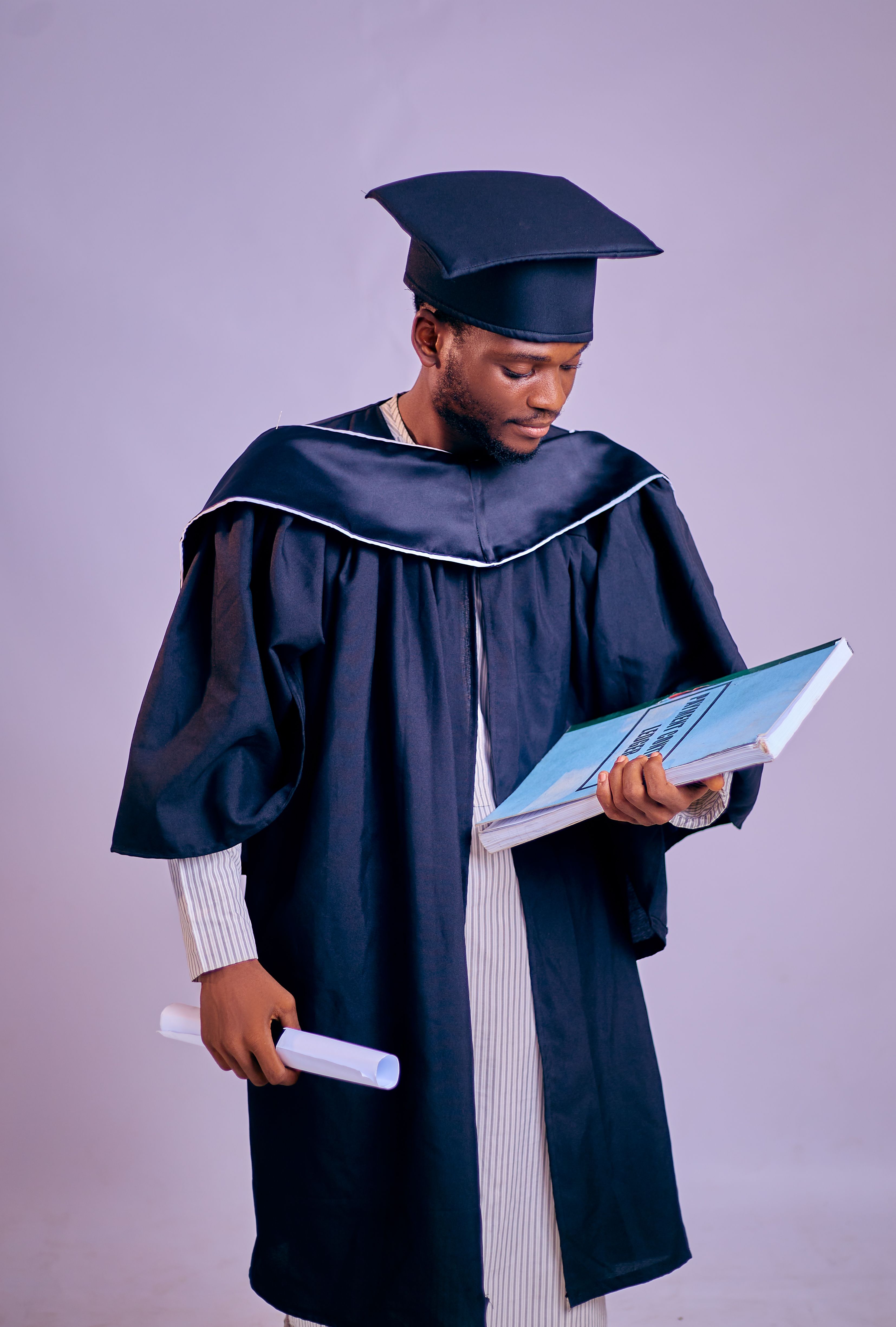 African American Graduate Holding Diploma · Free Stock Photo