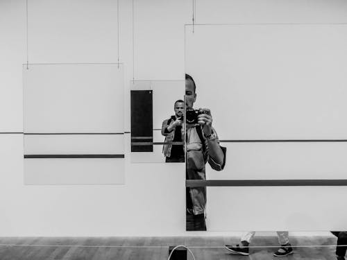 Monochrome Photo Of Man Holding Camera