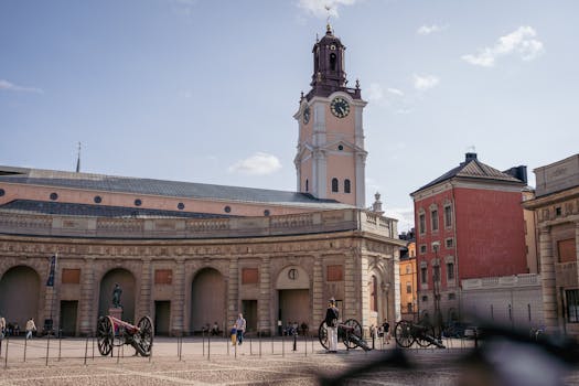 Scenic view of a historic courtyard with a prominent clock tower in Stockholm, Sweden.