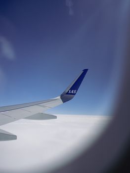 View from SAS airplane window over clouds en route to Sweden.