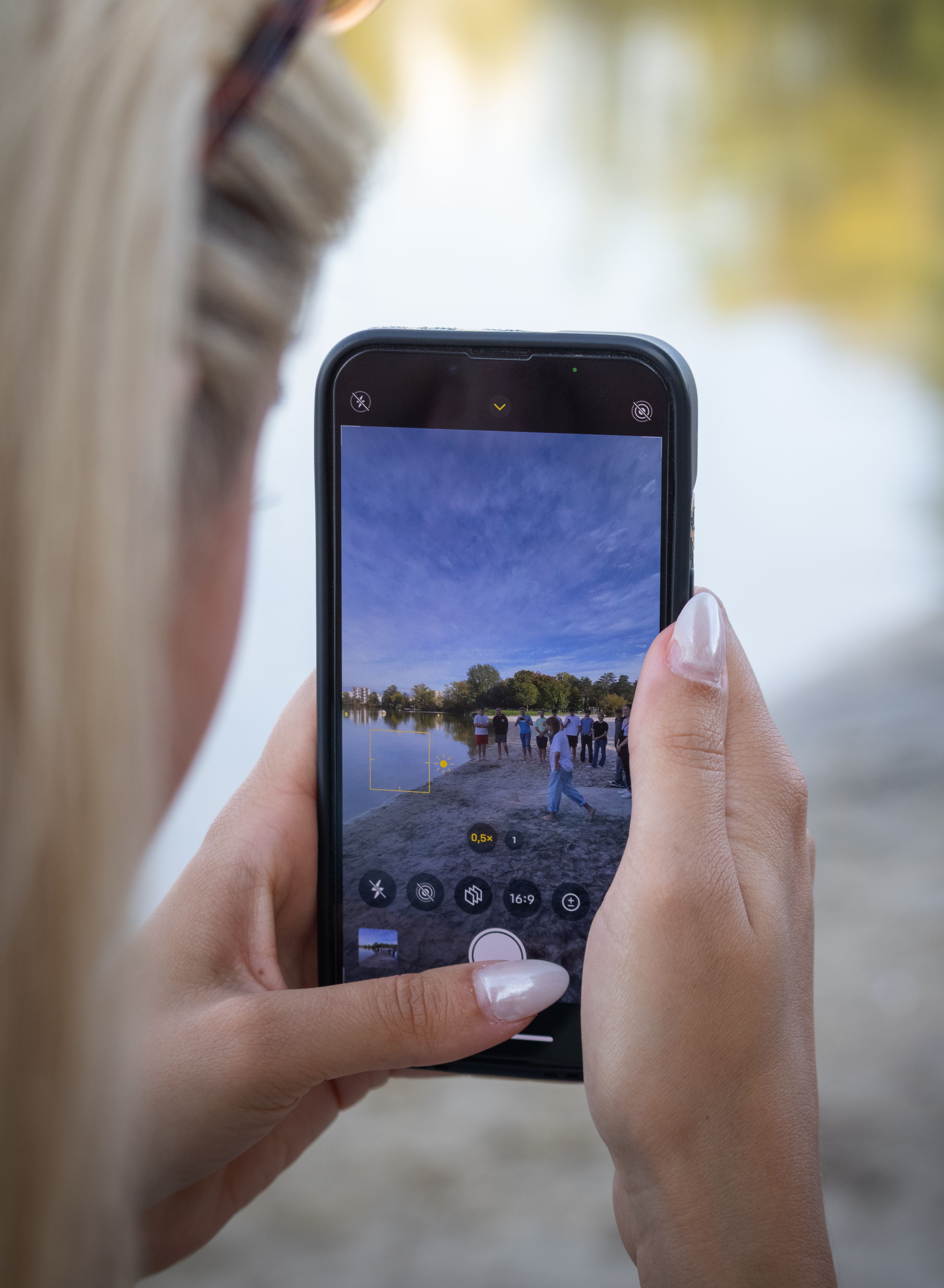 Close-up of Smartphone Capturing Scenic Lake View · Free Stock Photo