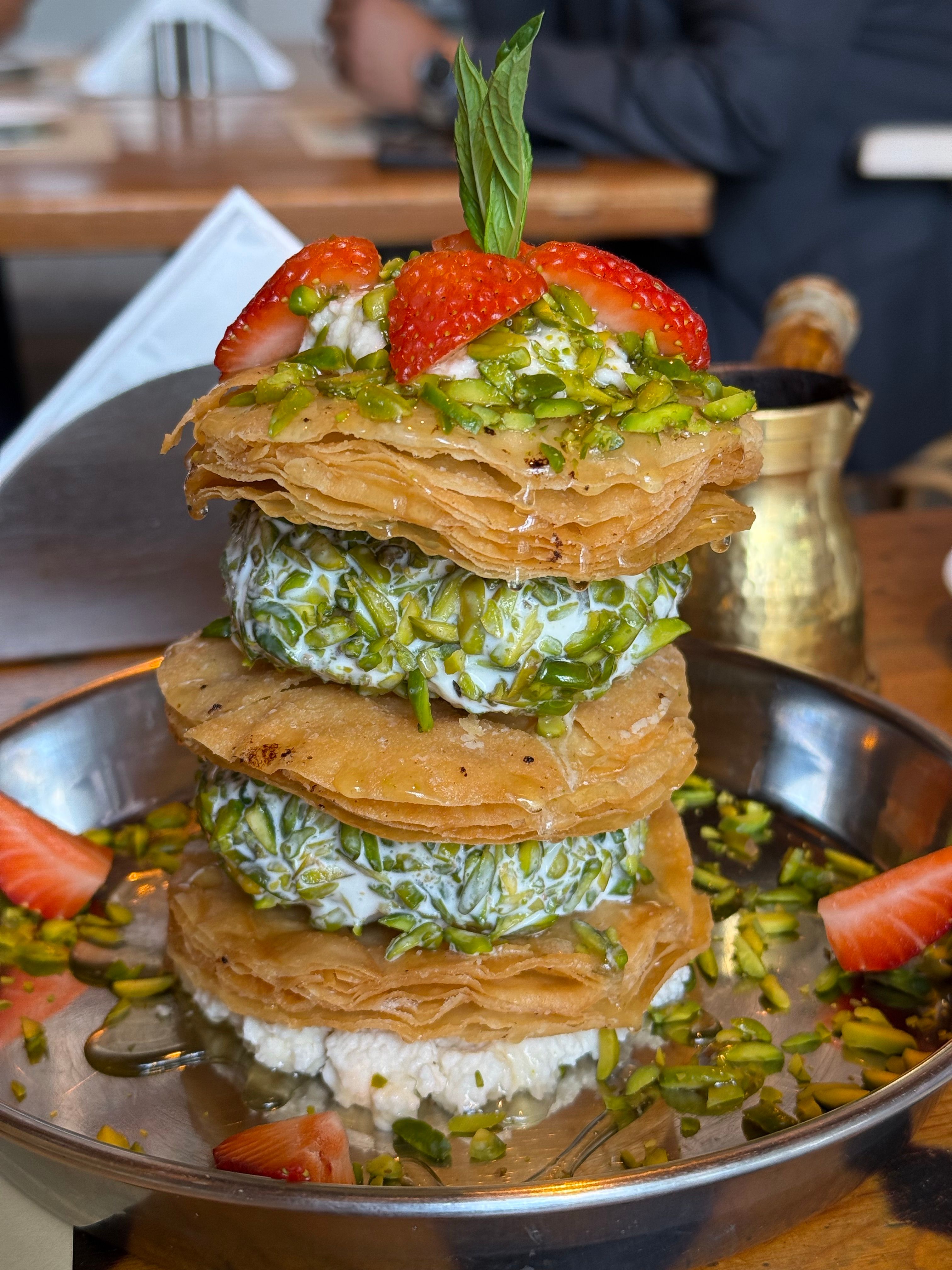 Delicious layered dessert featuring strawberries and pistachios, perfect for food enthusiasts.
