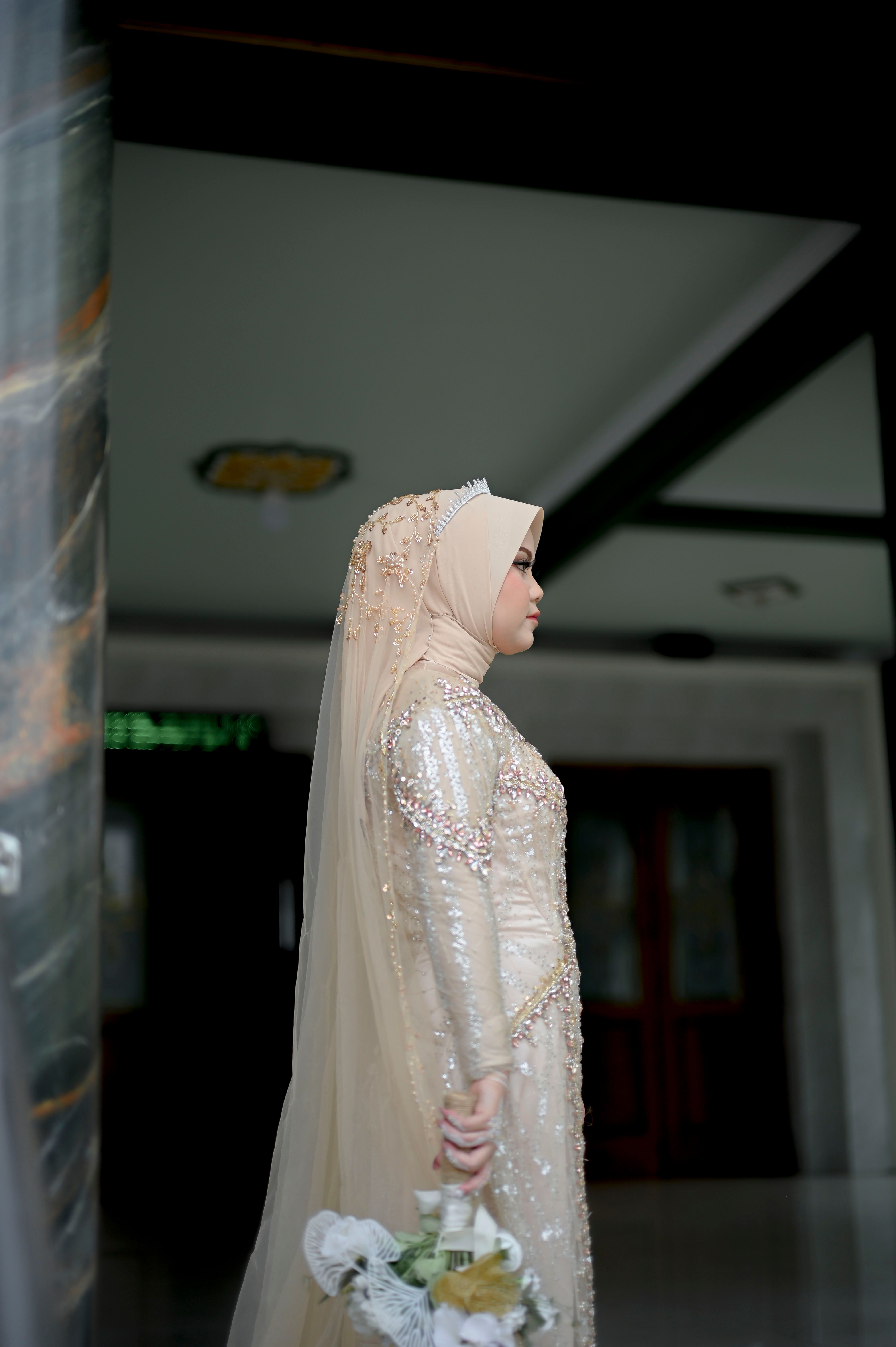 Elegant Bride in Hijab Holding Bouquet Indoors