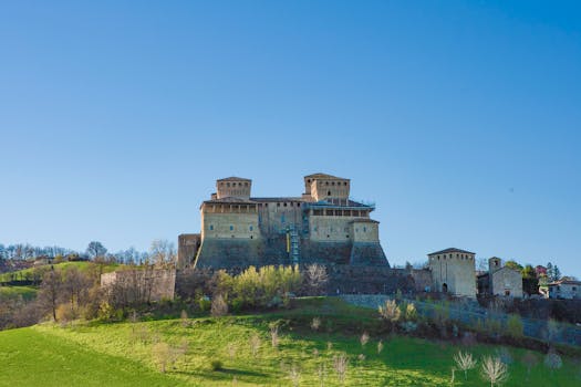 Stunning landscape featuring Torrechiara Castle against a vibrant blue sky in Italy.