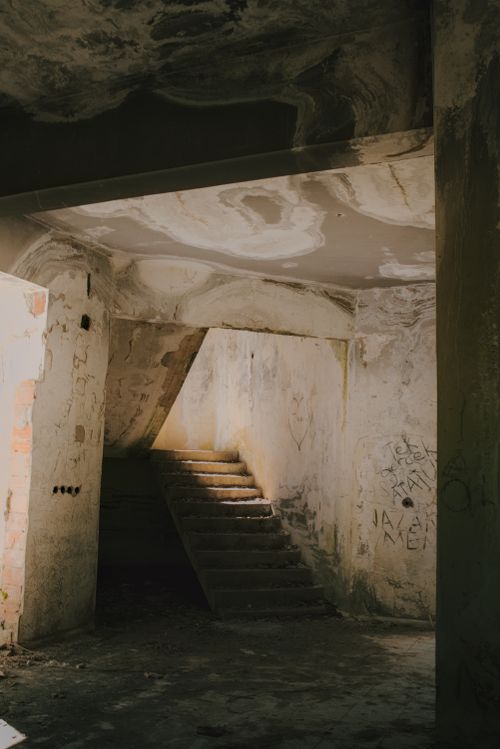 Free A sunlit staircase in an abandoned building, showcasing aged architecture. Stock Photo