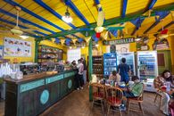 Vibrant café scene in Buenos Aires with people enjoying leisure time and colorful decor.