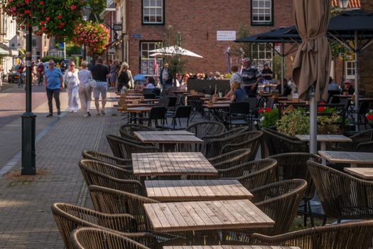 Charming outdoor cafe with stylish seating on a sunny day, perfect for a relaxing afternoon.