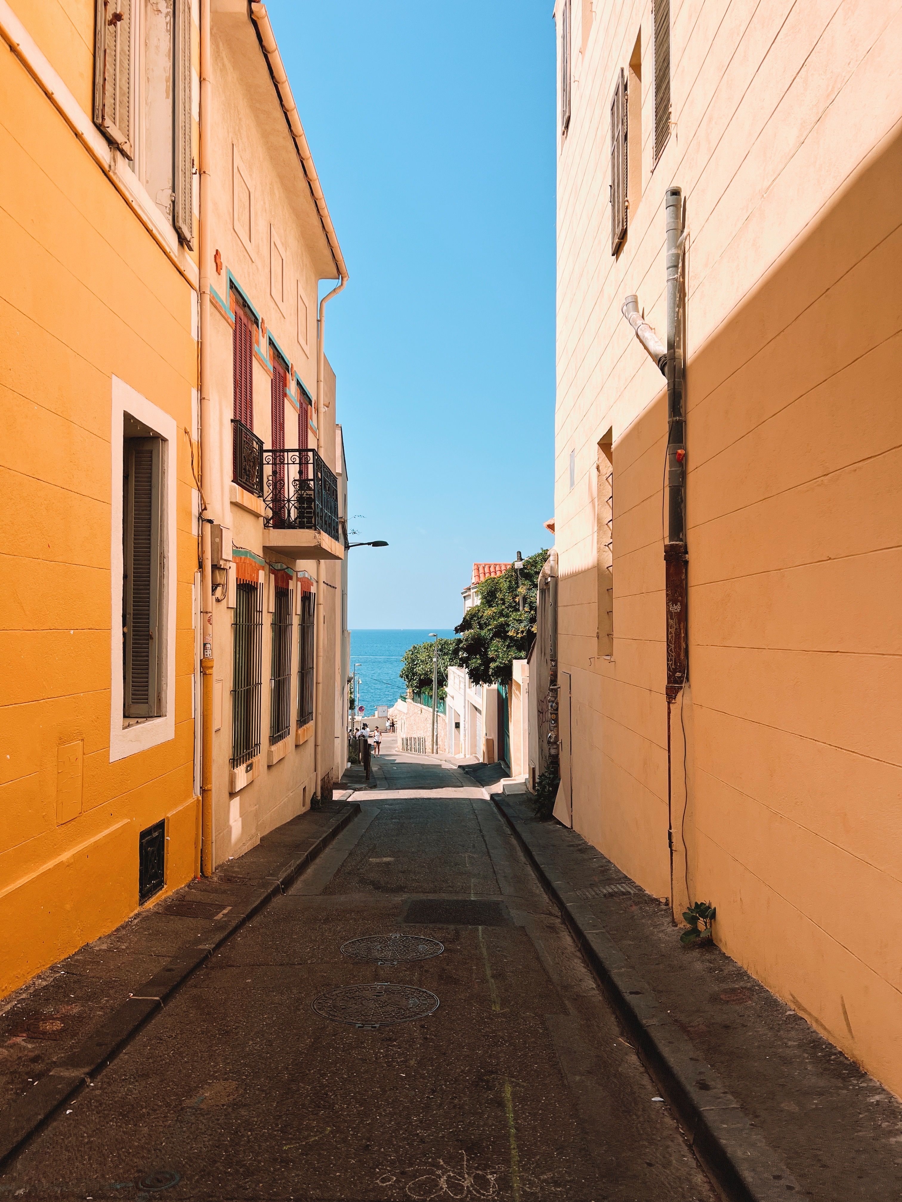 Narrow Street with Sea View and Bright Facades · Free Stock Photo