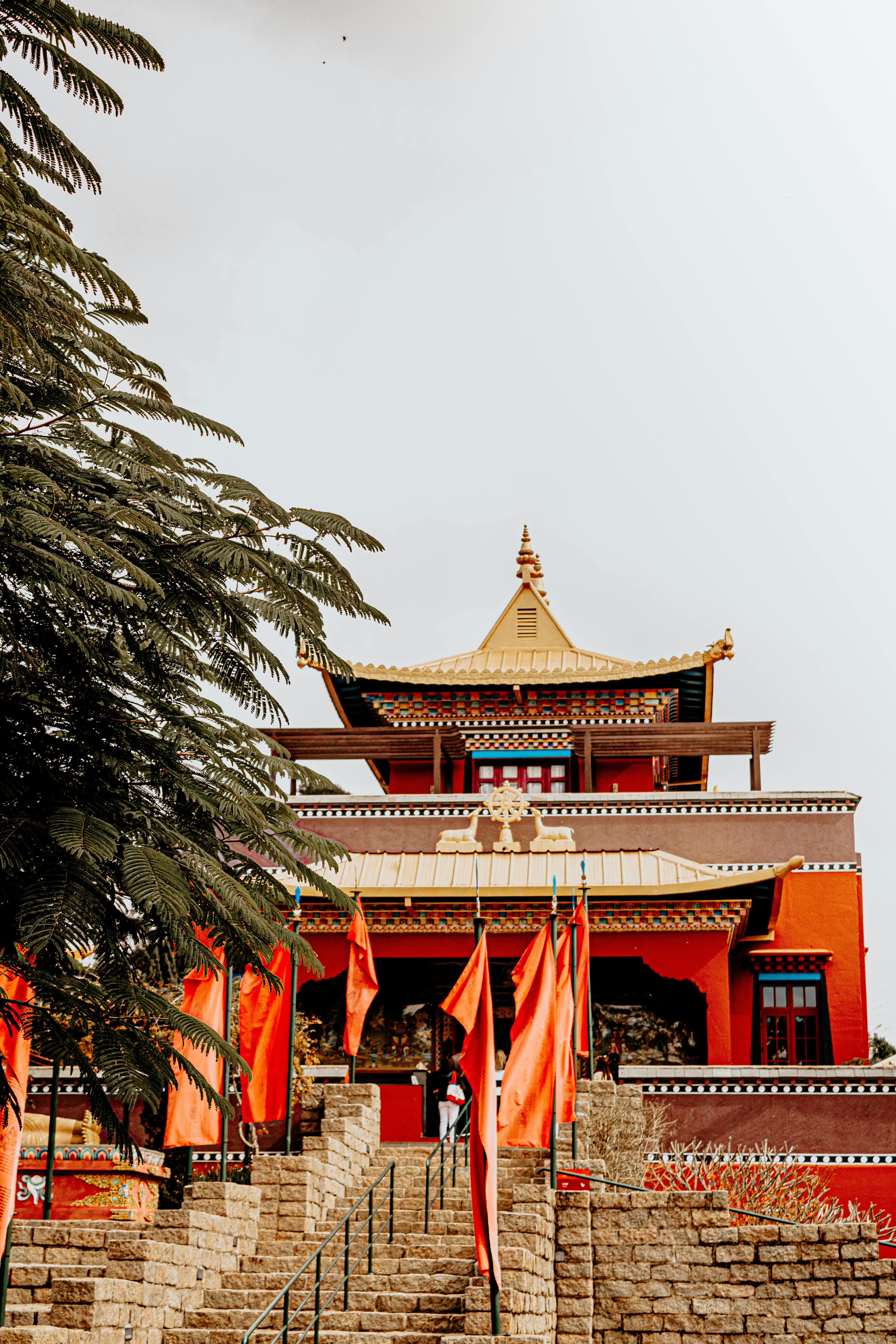 Buddhist temple in São Paulo with vibrant red flags and traditional architecture viewed from the front.