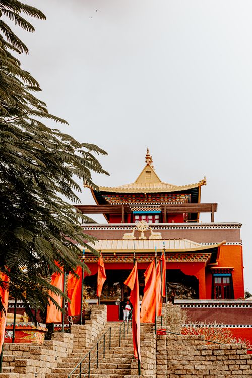 Free Buddhist temple in São Paulo with vibrant red flags and traditional architecture viewed from the front. Stock Photo