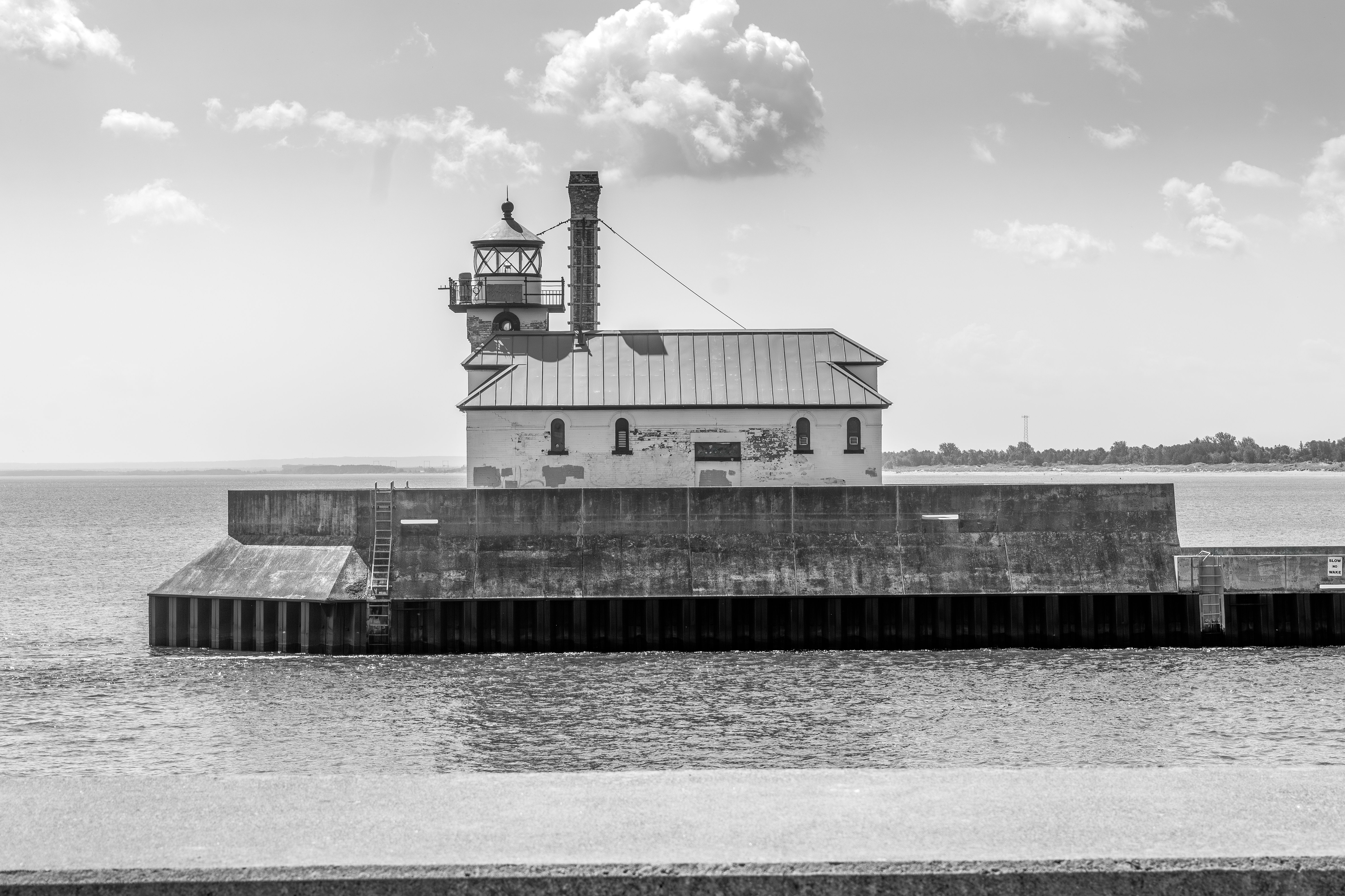 Stunning black and white photo of Duluth Harbor North Pier Lighthouse against Lake Superior.