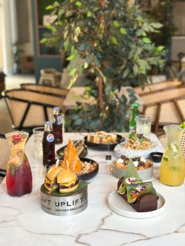 A luxurious spread of gourmet dishes and drinks elegantly arranged on a marble table.