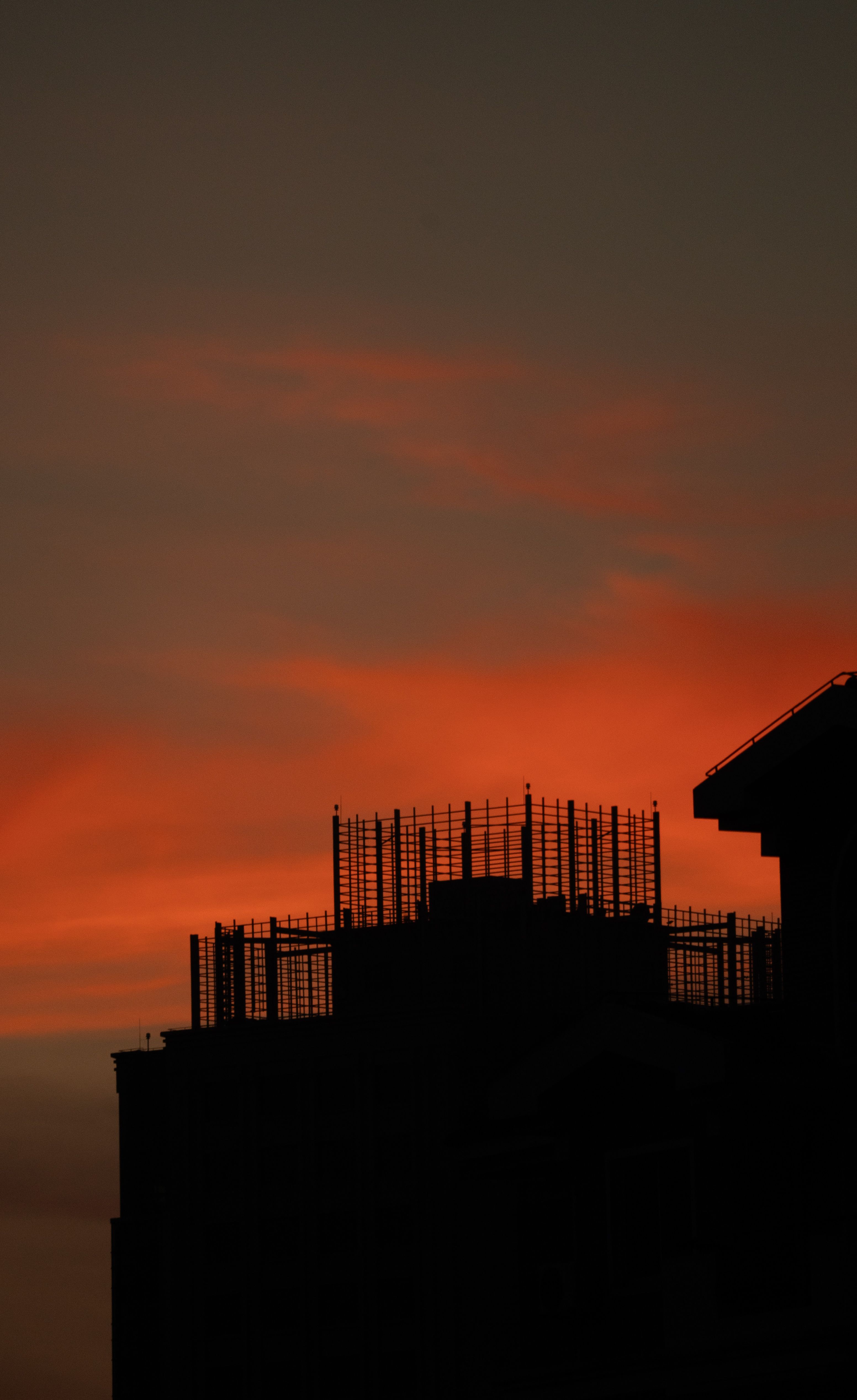 Cityscape Silhouette Against Vibrant Sunset Sky · Free Stock Photo