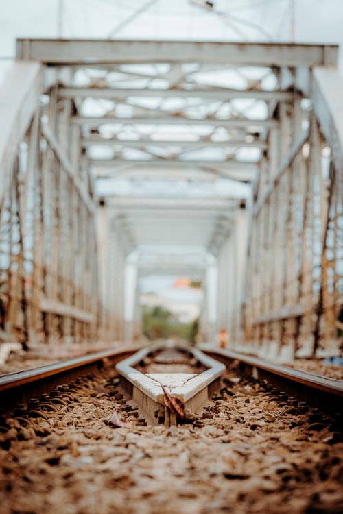 Free Detailed view of a railway track running through a steel bridge with intricate geometry. Stock Photo