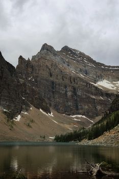 Scenic view of the Rocky Mountains reflecting in a tranquil lake in Banff, Canada.