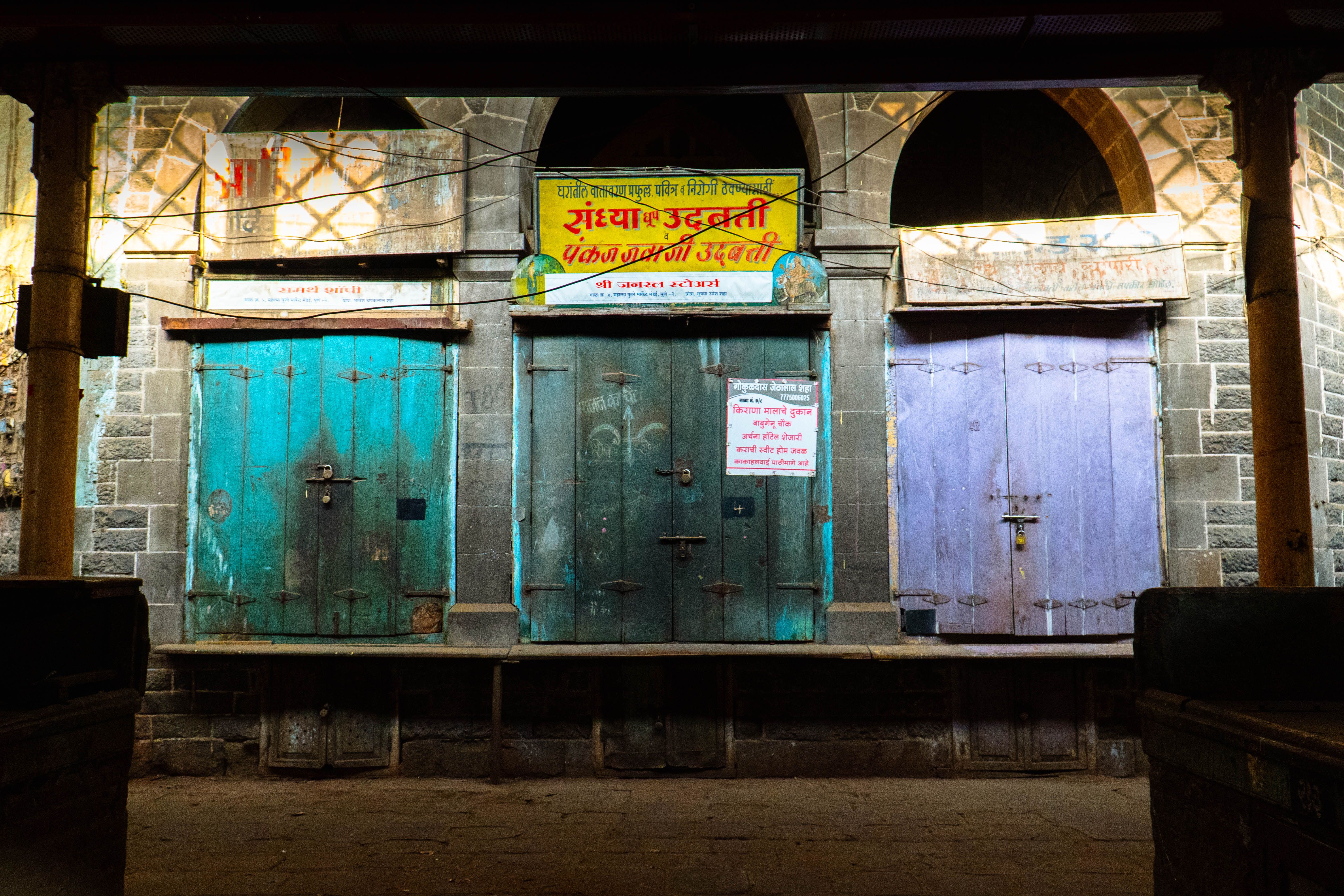 Colorful arched doorways at night in a historic street setting in India.